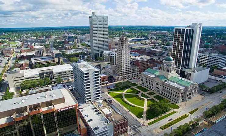 20 Things To Do In Fort Wayne That Are Actually Fun things to do in fort wayne today Image of Aerial shot of Downtown Fort Wayne with several high rise buildings and the courthouse with green courtyard centered.