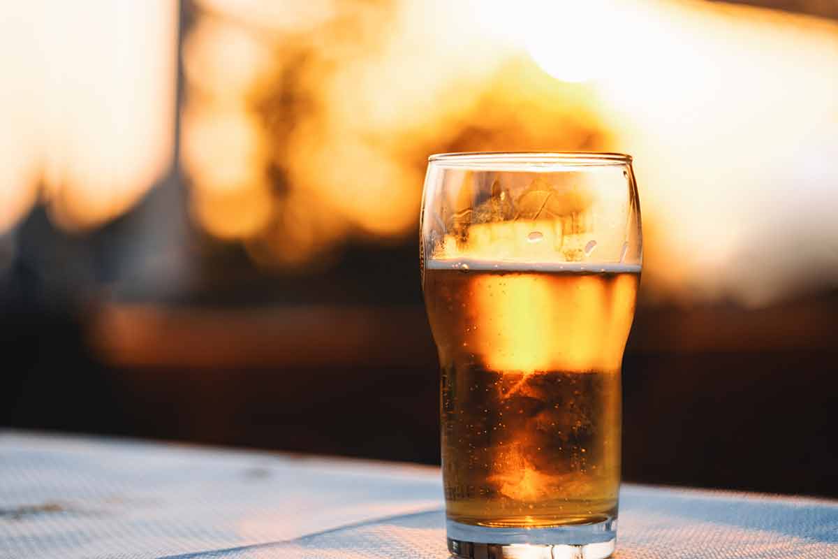 things to do in fresno this weekend - A close-up of a refreshing cold lager beer on a table against sky during the sunset.