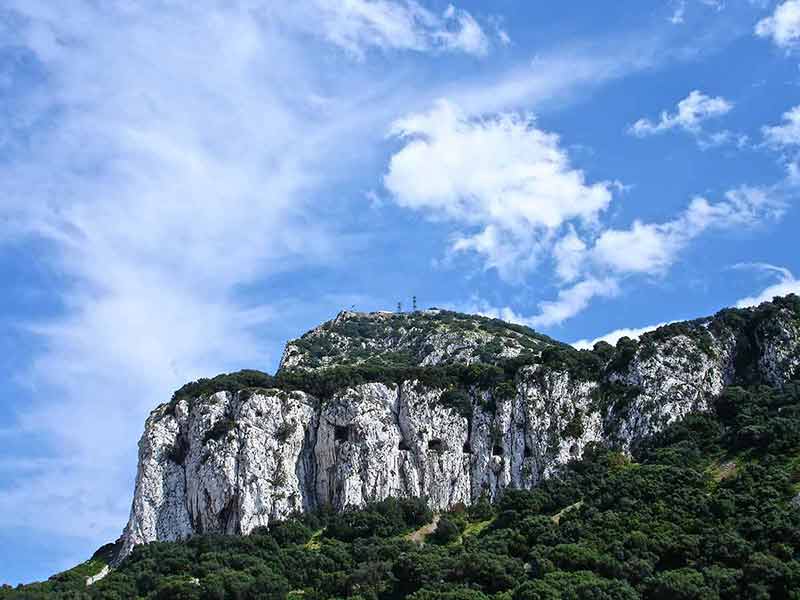things to do in gibraltar tunnels drilled into the rock on a blue-sky day