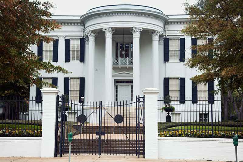 governor's mansion white building with front gate
