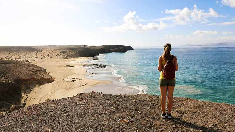 things to do in lanzarote for families hiker enjoying view of Playas de Papagayo