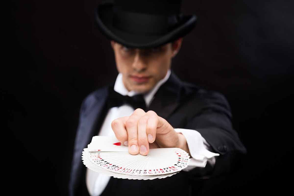things to do in las vegas at night magician in top hat showing trick with playing cards