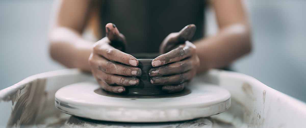 things to do in lexington this weekend a woman's hands close up, the masterful studio of ceramics works with clay on a potter's wheel.