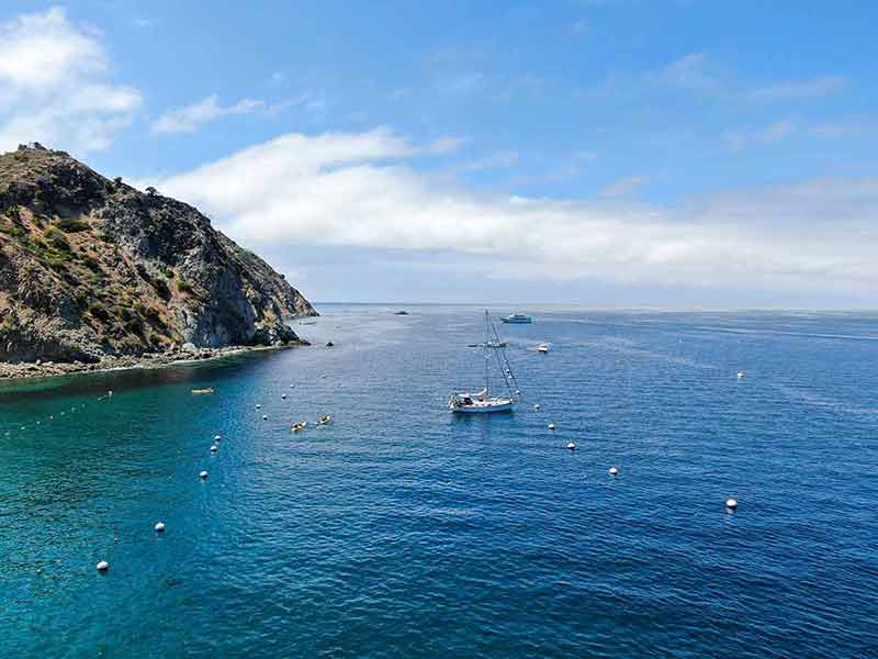 things to do in long beach island Aerial view of Avalon Bay with sailboat in Santa Catalina Island