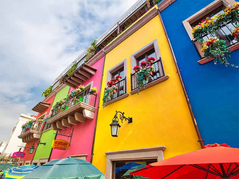 things to do in monterrey mex brightly coloured buildings, balconies with flowers