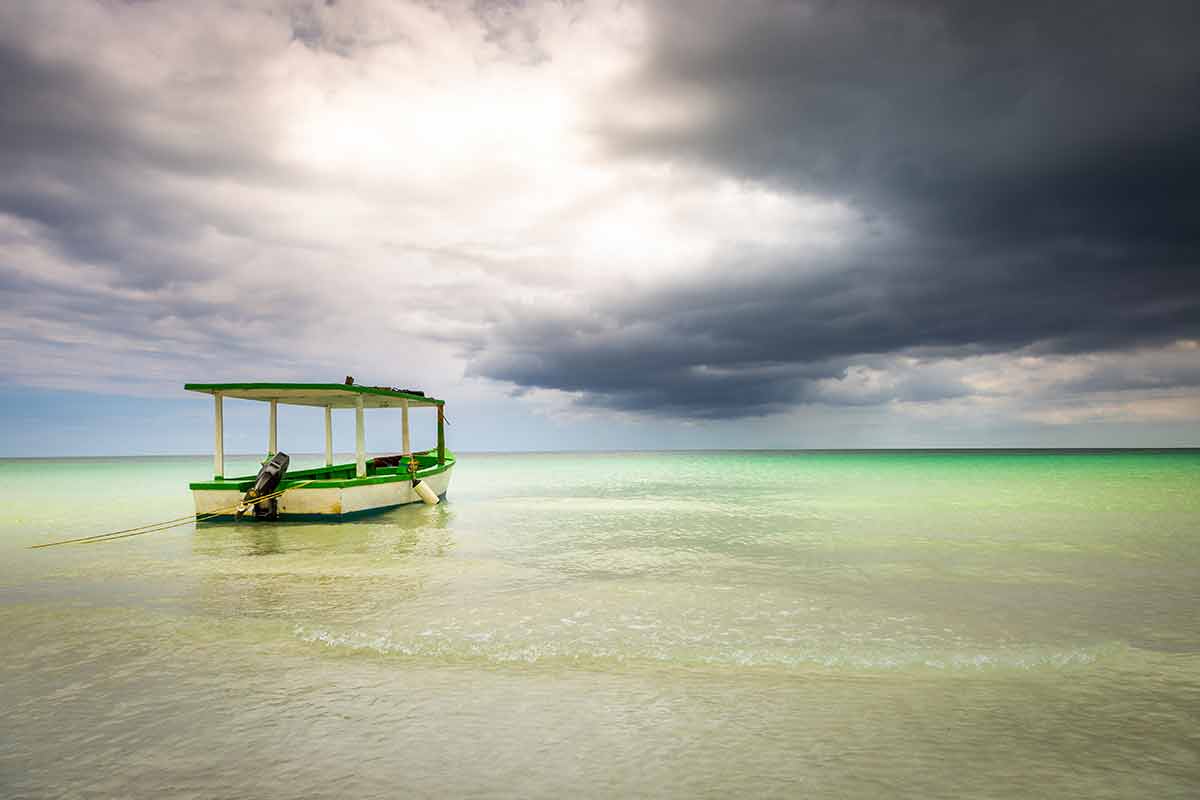 Dramatic Sky Over Beach With Motorboat, Negril Seven Mile Beach, Jamaica