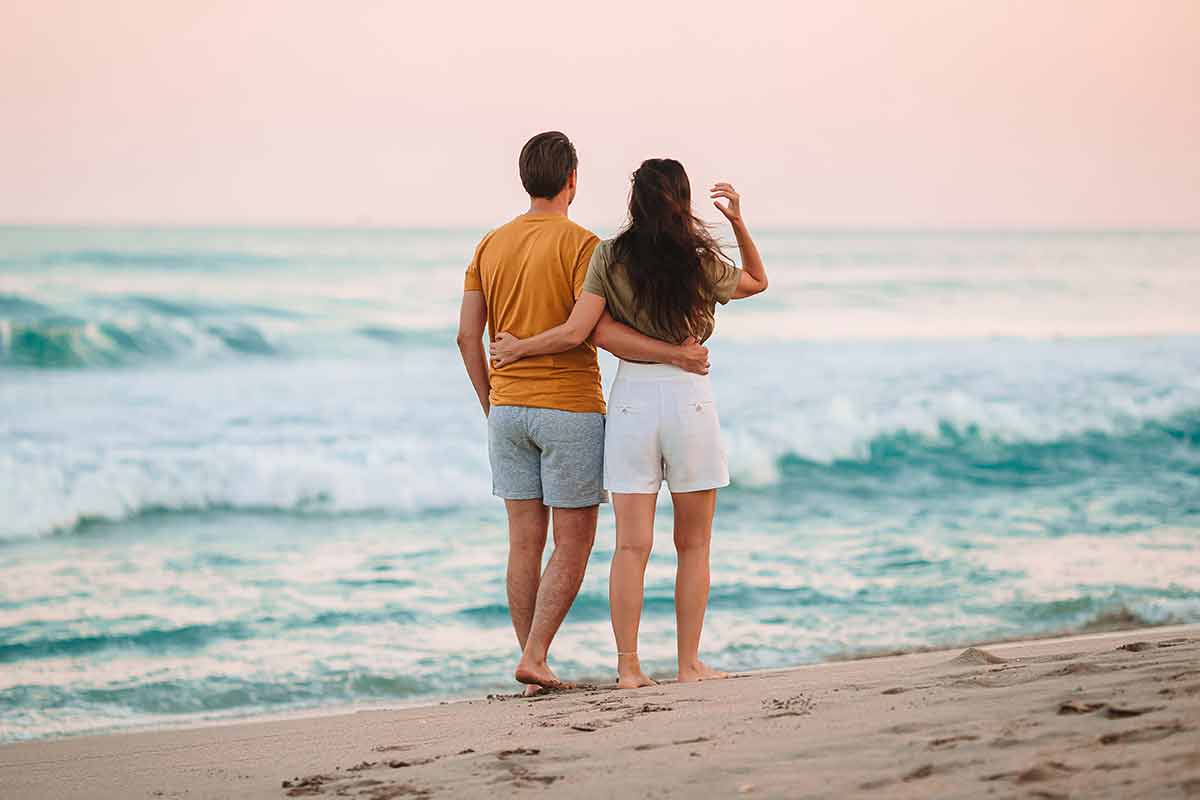 couple on neptune beach at sunset