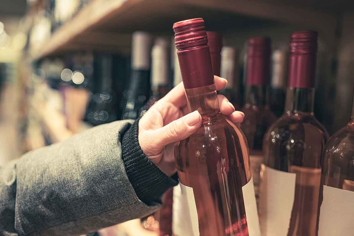 hand choosing bottle of wine