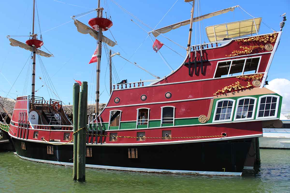 red pirate ship docked at the wharf