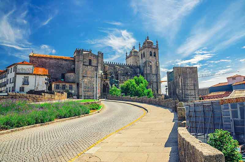 things to do in porto for a day historical centre, blue sky white clouds in sunny summer day background,
