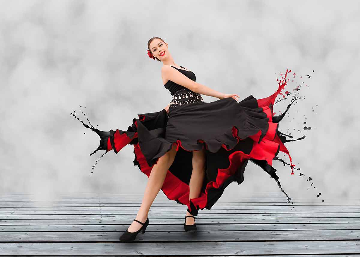 things to do in province of seville Flamenco dancer with dress turning to paint splashes on grey floorboard.
