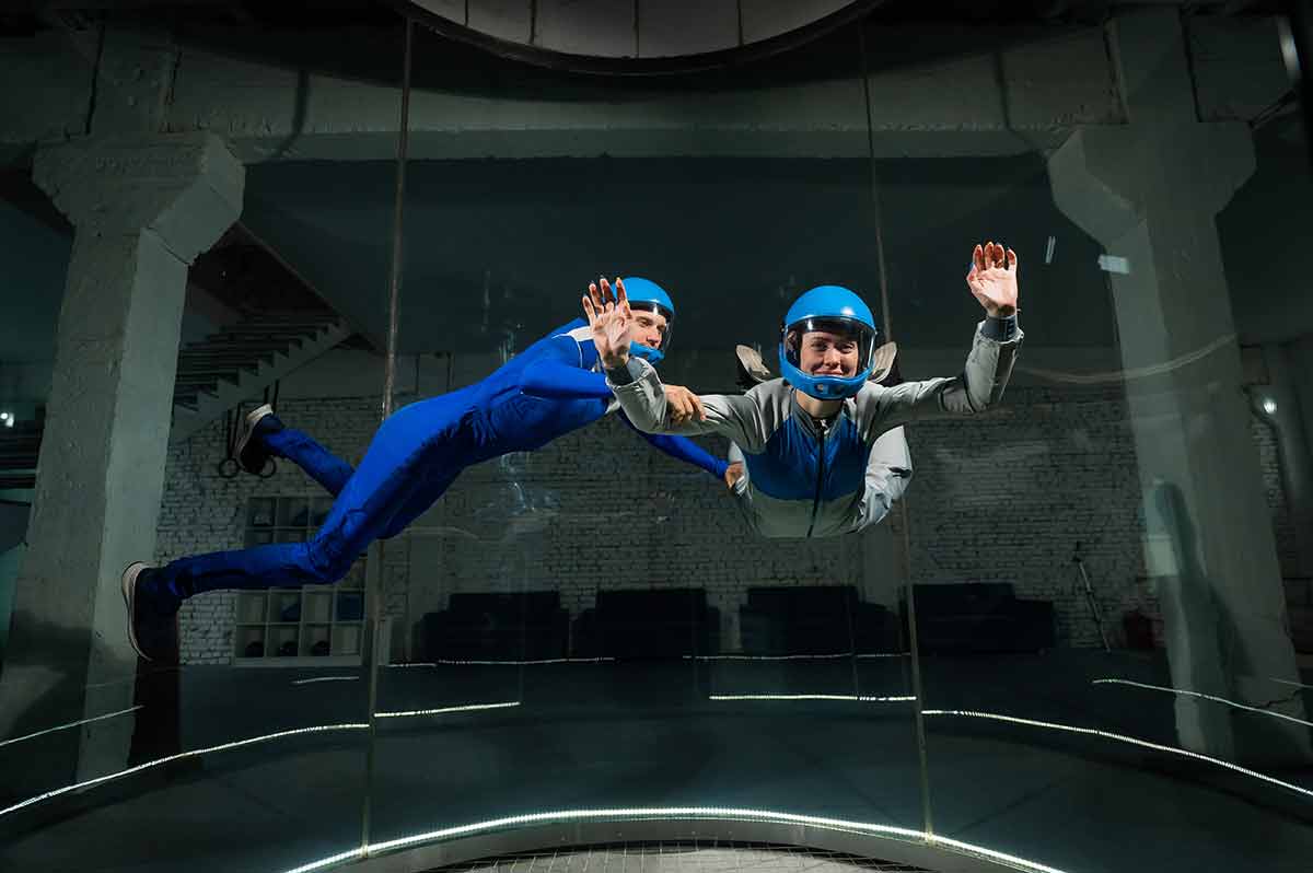A Man And A Woman Enjoy Flying Together In A Wind Tunnel