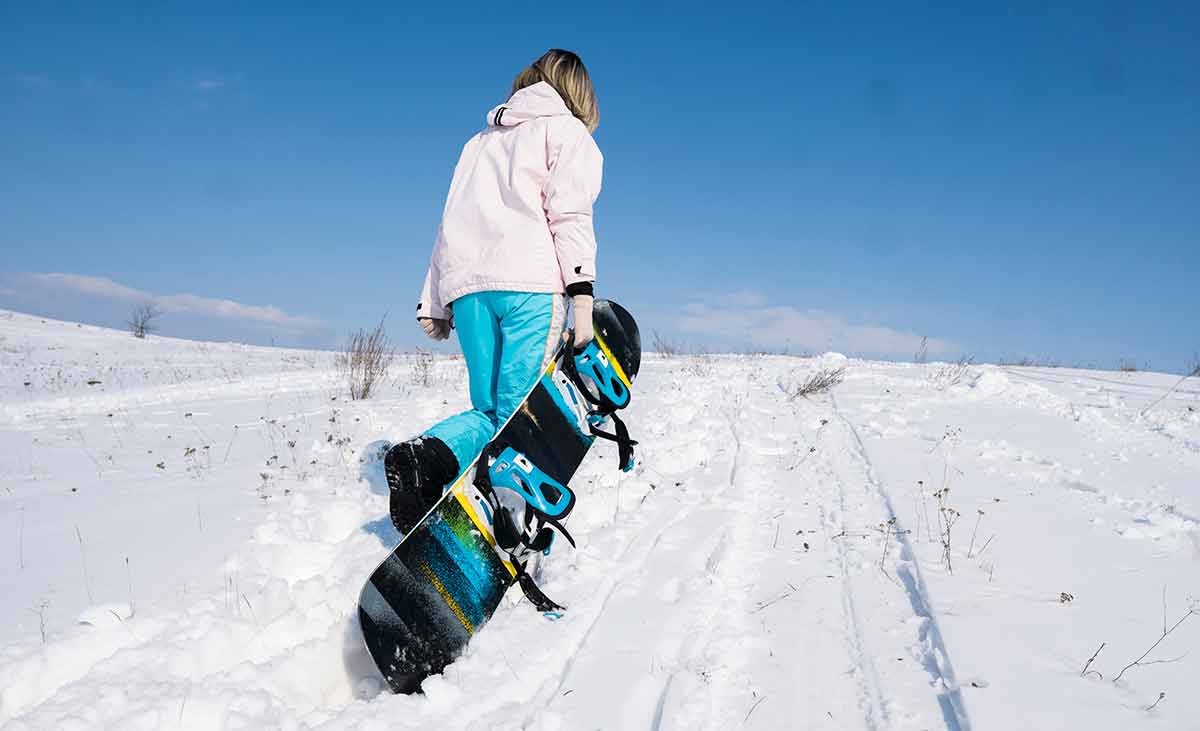 Girl Snowboarder With A Snowboard