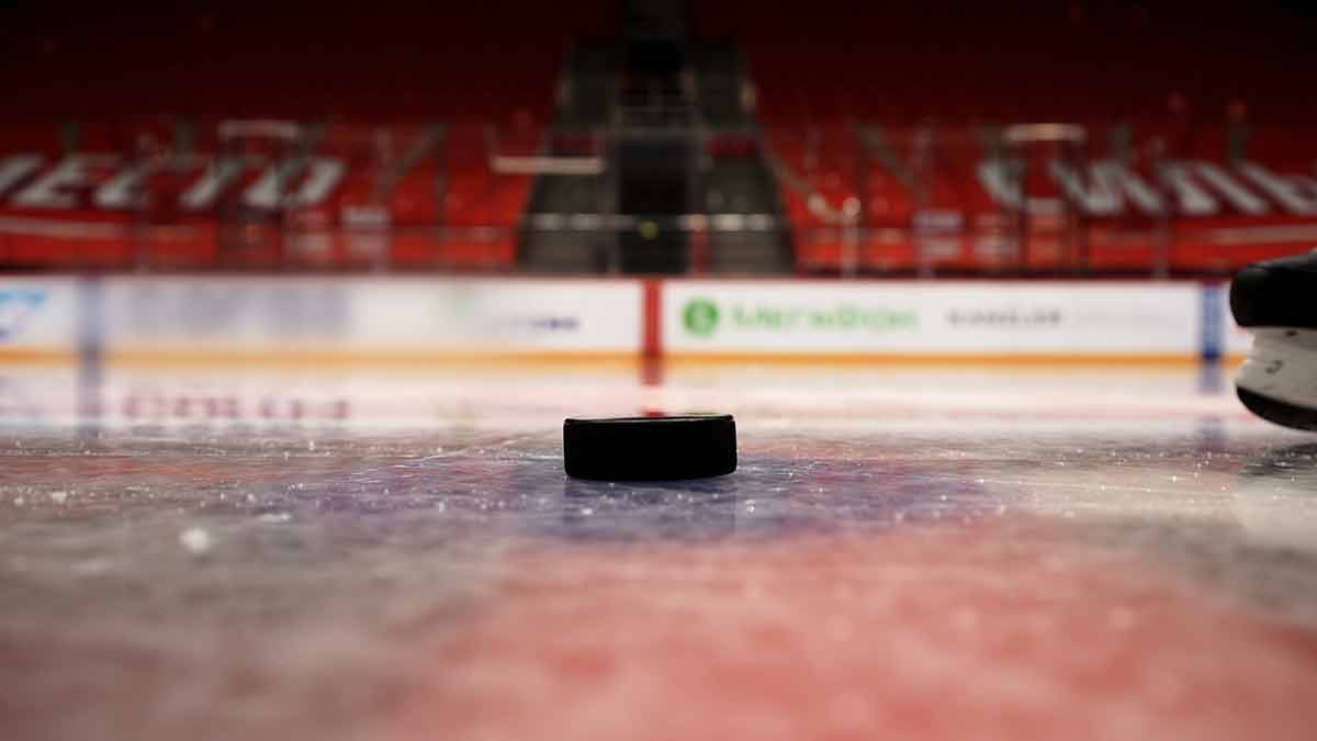 Close Up Of A Hockey Puck Falling On Ice