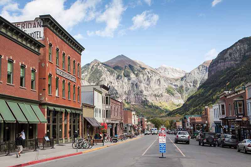 Telluride village shops with mountains in the background