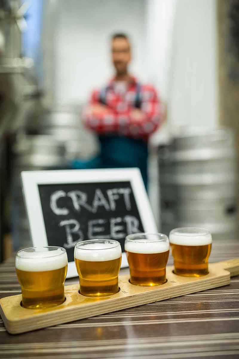 Four Glasses Of Craft Beer On Beer Sampler Tray