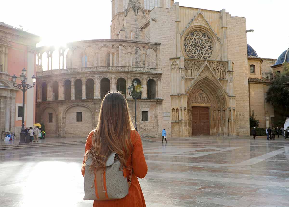 Back view of beautiful girl visiting Valencia Cathedral.