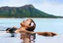20 Things To Do In Waikiki That Aren’t Just Lying on the Beach things to do in waikiki hawaii Hawaii vacation wellness pool spa woman relaxing in warm water at luxury hotel resort.