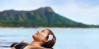 things to do in waikiki hawaii Hawaii vacation wellness pool spa woman relaxing in warm water at luxury hotel resort.