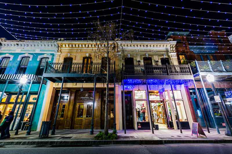 historic shopfronts lit up at night