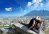 ballet dancer posing on a rock with Monterrey and mountains in the background