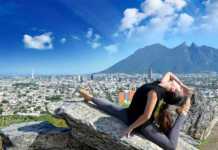 ballet dancer posing on a rock with Monterrey and mountains in the background
