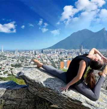 ballet dancer posing on a rock with Monterrey and mountains in the background