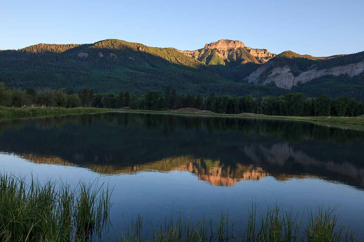 san juan mountains reflected in the lake