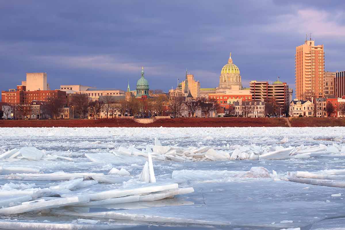 Harrisburg, Pennsylvania, illuminated by evening sunlight as viewed from City Island across the frozen Susquehanna River.