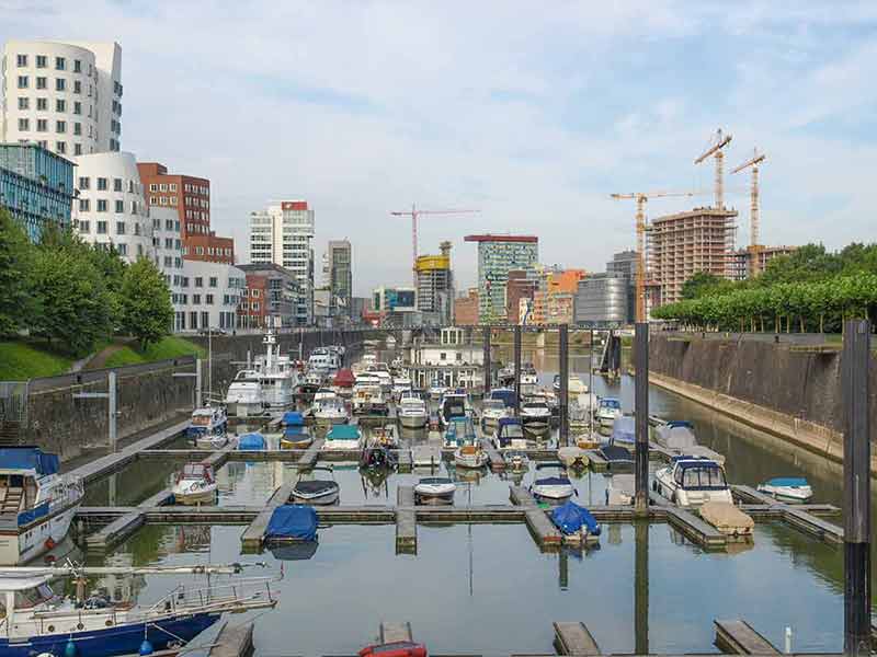 boats moored in Medienhafen Duesseldorf with modern buildings in the background