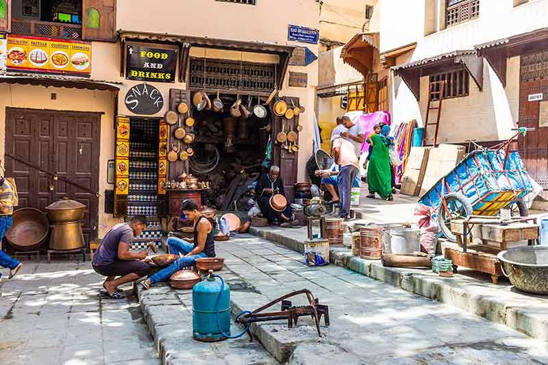 People In Their Traditional Activity Of Crafting With Copper In The Medina