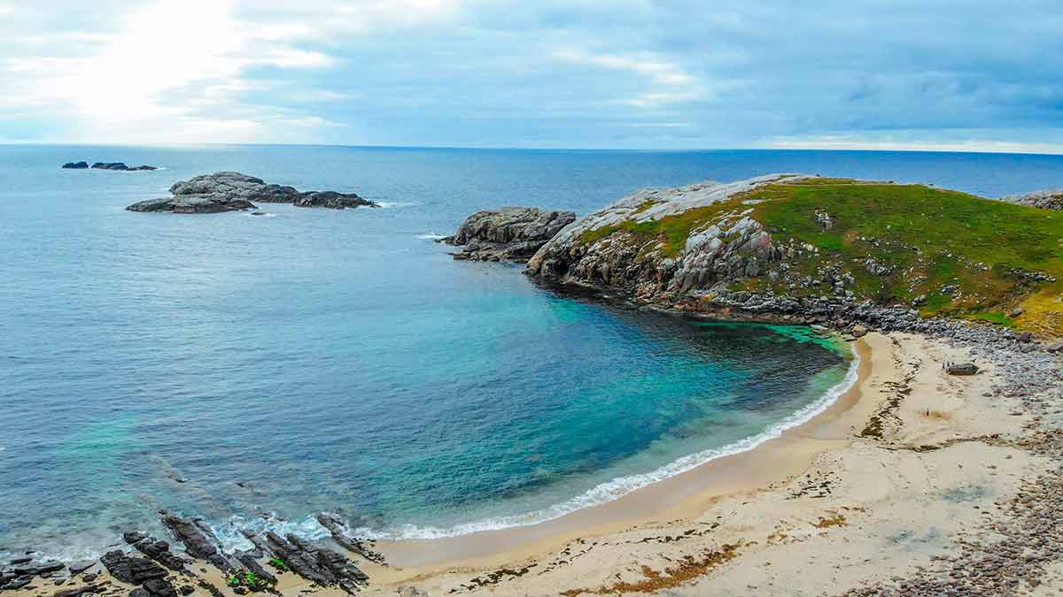 top beaches in uk clear water, sand and hill at Sheigra Beach