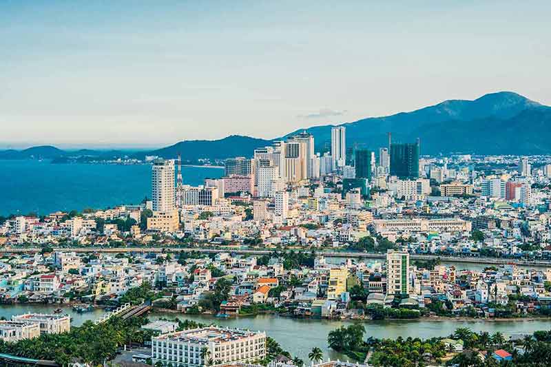 panoramic daytime view of Nha Trang with mountains in the background