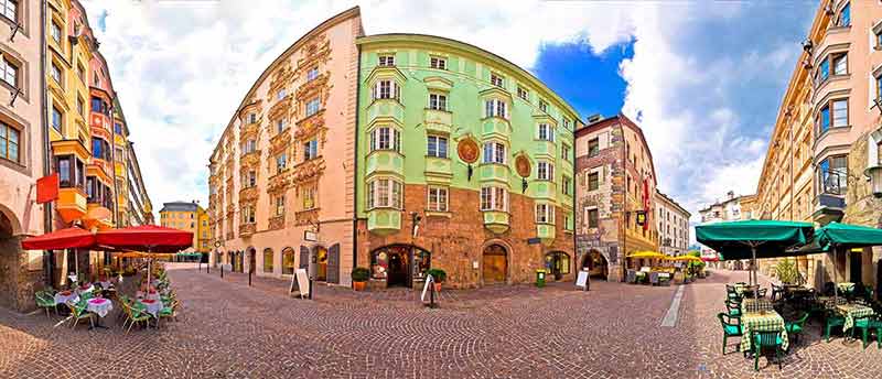 top ten things to do in innsbruck wide view of old town with cafes and colourful buildings