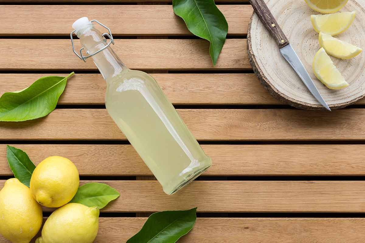 top things to do in auburn al Horizontal image of glass bottle full of lemonade with lemons in the lower left corner and natural cutting board with old knife and lemon slices on wooden table.