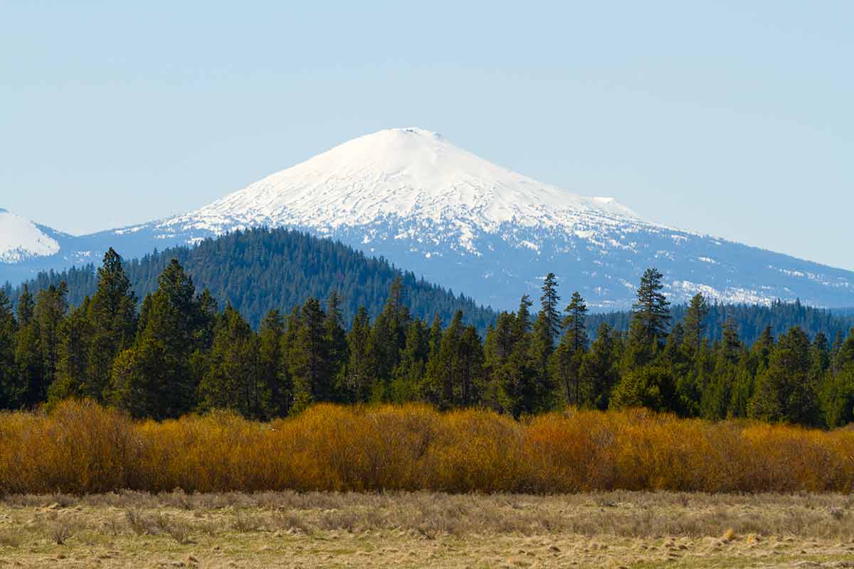 top things to do in bend oregon Mount Bachelor in Oregon is photographed from a distance to create this nature scenic landscape of the snow-capped mountain.