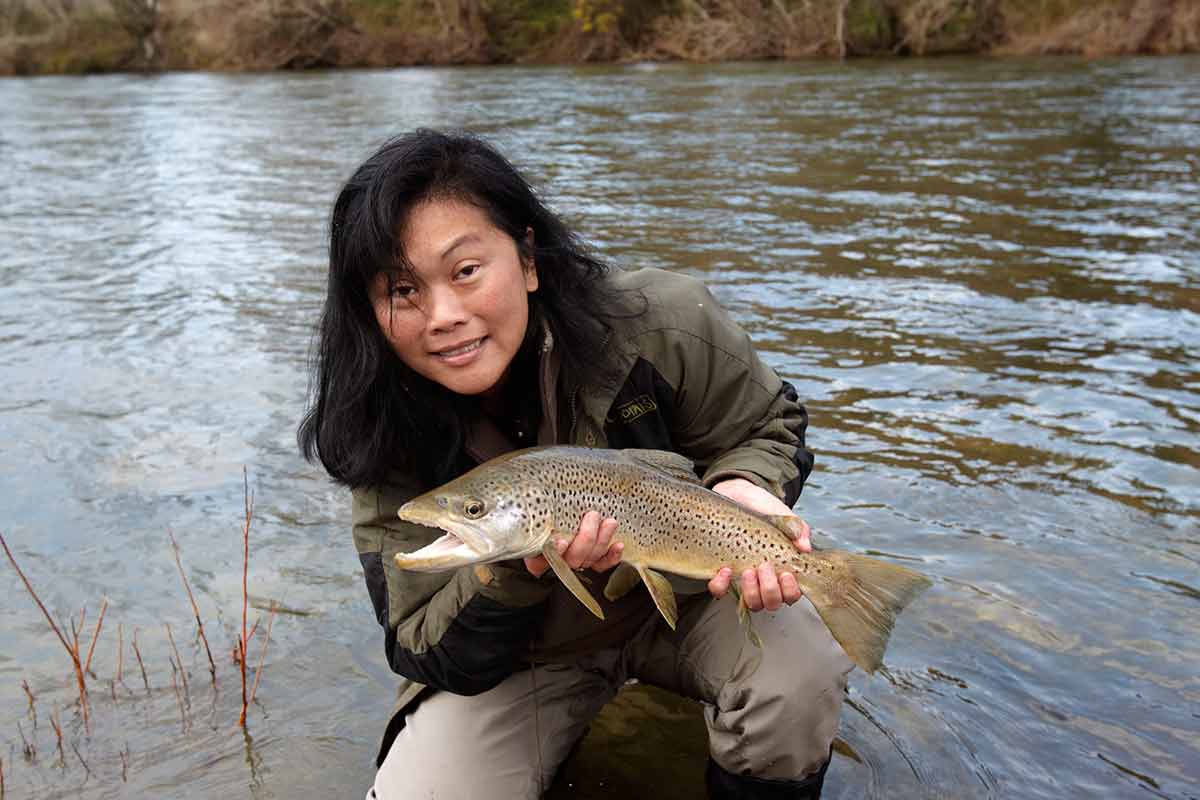 woman and fish fly fishing in nelson