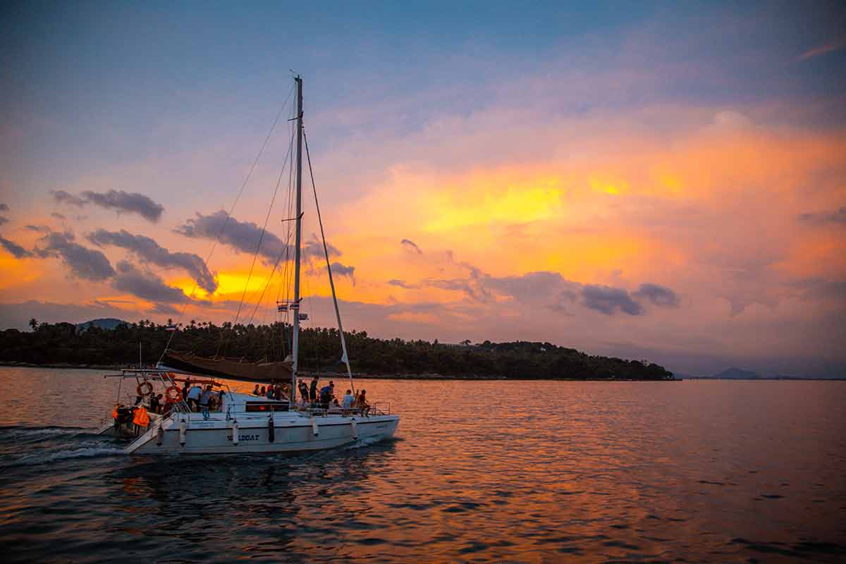 Sailing Boat During Sunset At Promthep Cape In Phuket Peninsula, Thailand