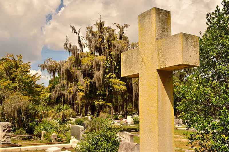 A cross memorial stands out at Bonaventure Cemetery in Savannah Georgia.