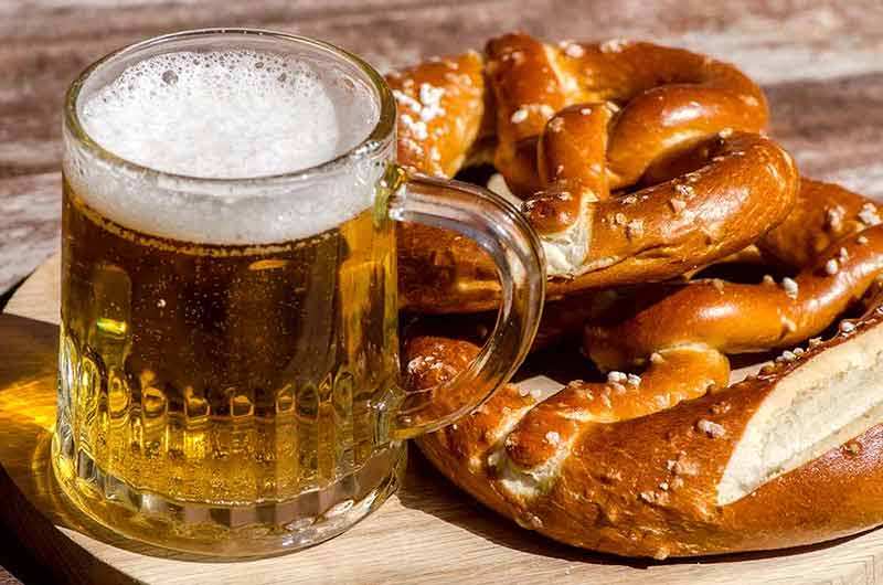 traditional german drinks bavarian beer and a pretzel on wood