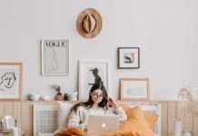 woman in bed watching travel shows on netflix