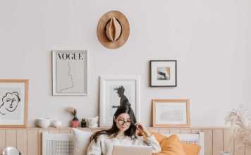 woman in bed watching travel shows on netflix