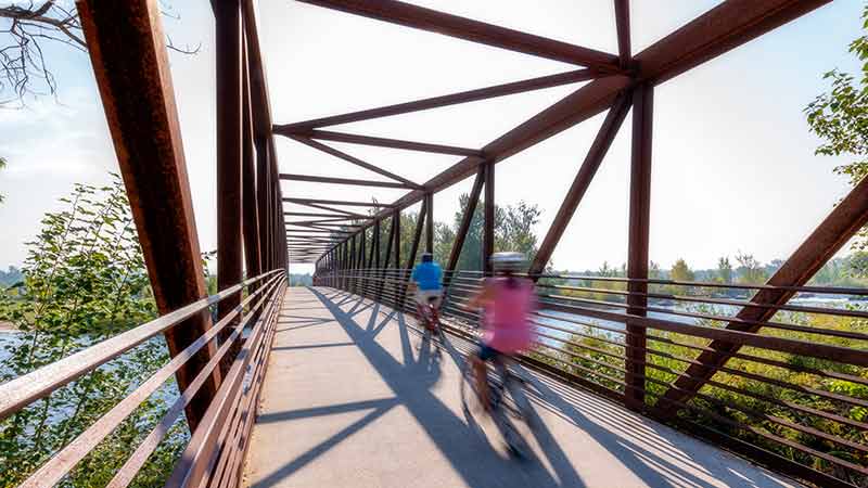 tun things to do in boise id Boise River Greenbelt cyclists crossing a bridge