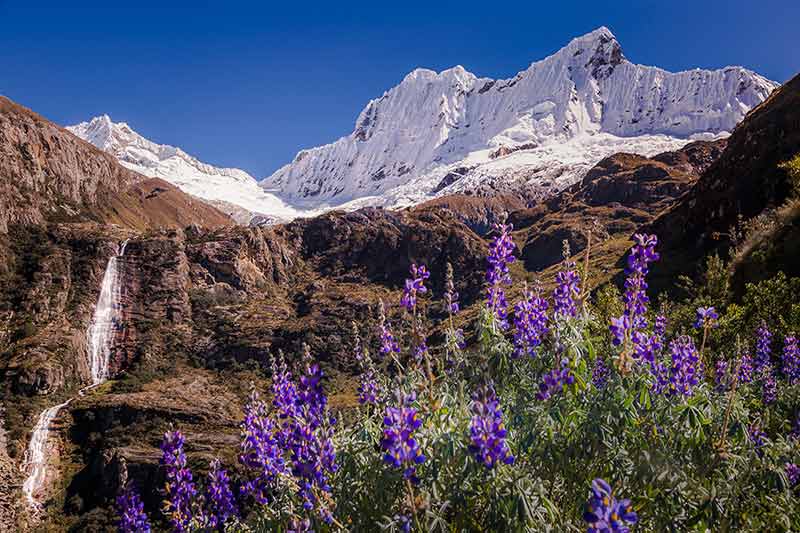 Waterfall and Huascaran massif in Cordillera Blanca