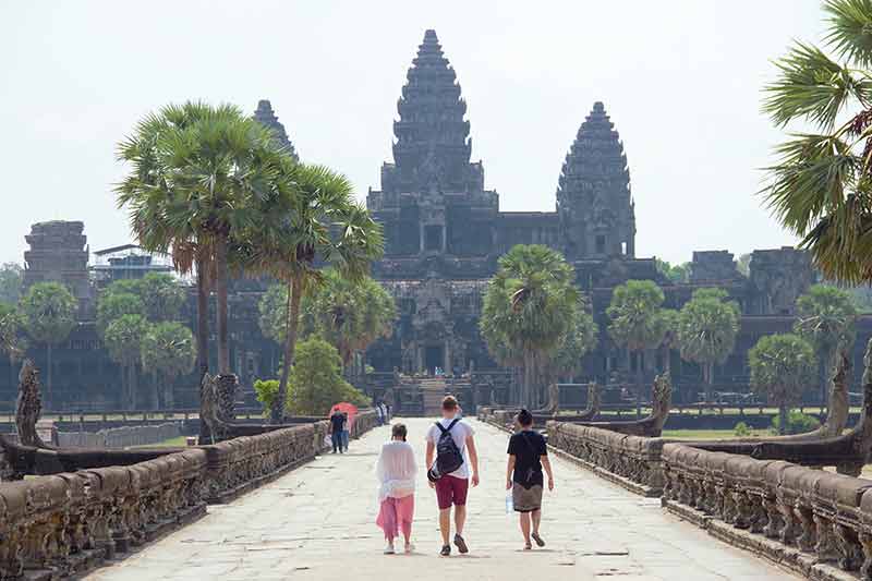 Angkor wat entrance people walking to it inCmbodia