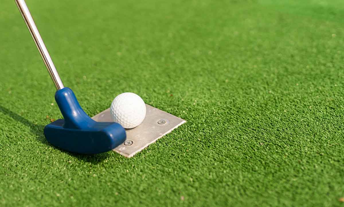 Golf Club And A Ball on a put-put green