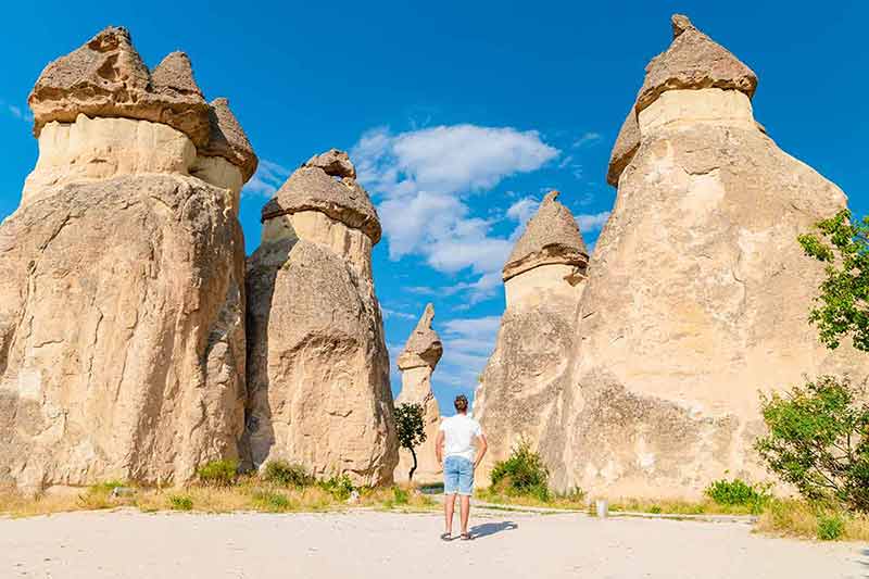 unique things to do in turkey man standing in front of soaring rocks