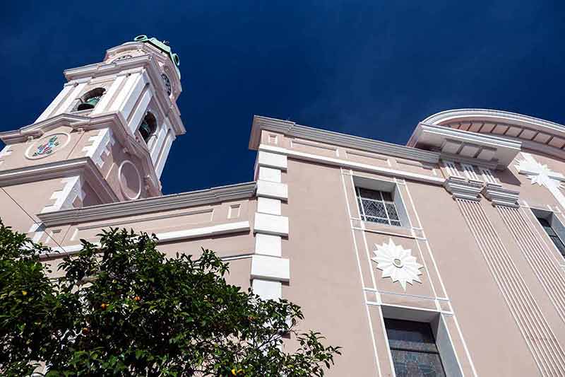 unusual things to do in gibraltar pastel cathedral building constrasted with the blue sky