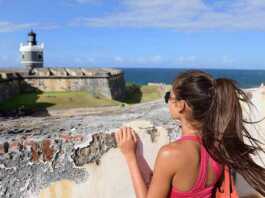 us national parks puerto rico woman in San Juan, looking down at the fort Castillo San Felipe Del Morro