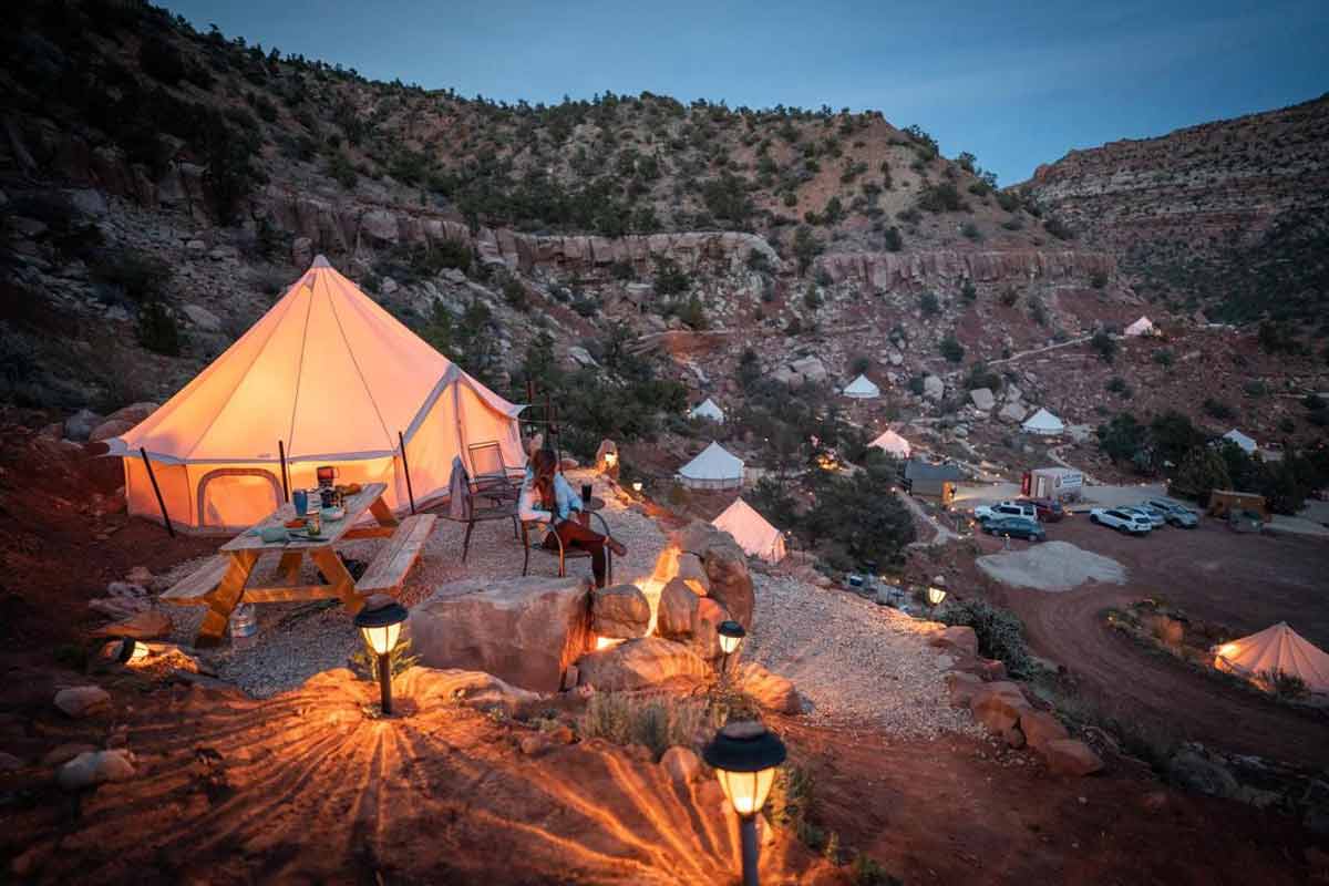 utah Zion Glamping Adventures woman sitting outside tent admiring the view